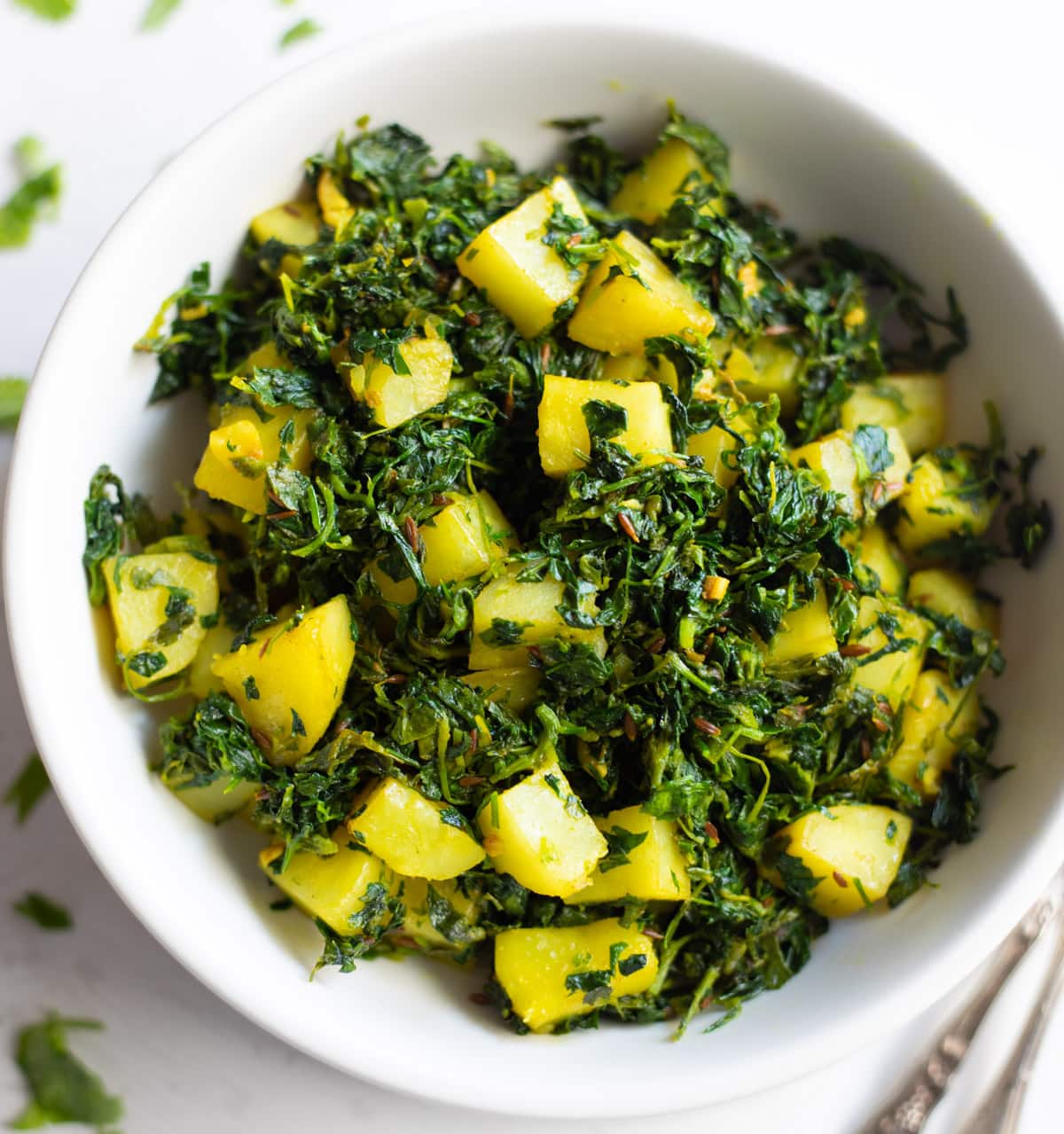 Freshly harvested methi leaves cooked to perfection, showcasing their vibrant green color and aromatic flavor.