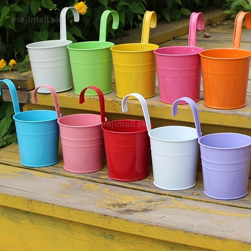 Colorful metal pot with handles on a wooden surface