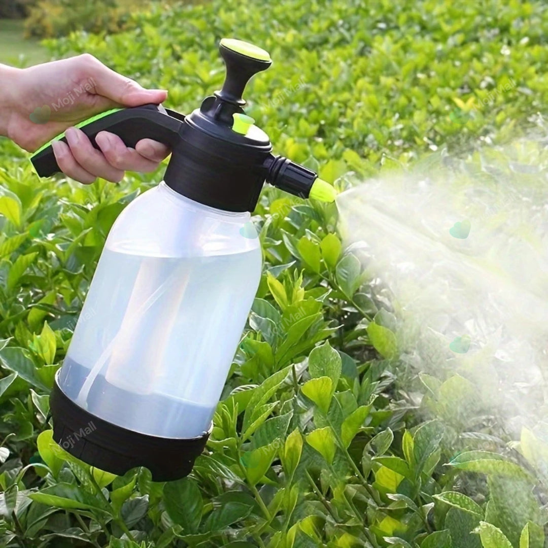 Person using a handheld sprayer to water plants in a garden by moji mall