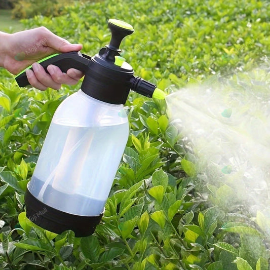Person using a handheld sprayer to water plants in a garden by moji mall