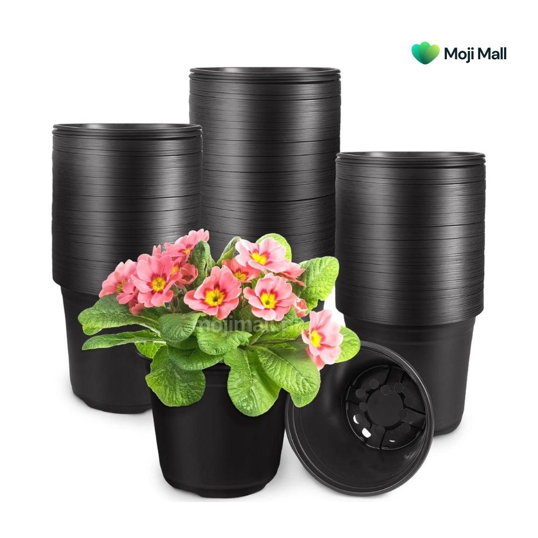 Black plastic nursery pots shown in stacked groups, with one pot holding pink flowers and green leaves and a second pot shown open to reveal the drainage insert, on a white background. Moji Mall logo is visible in the top right.