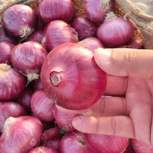 Group of purple onions with green tops on a brown surface