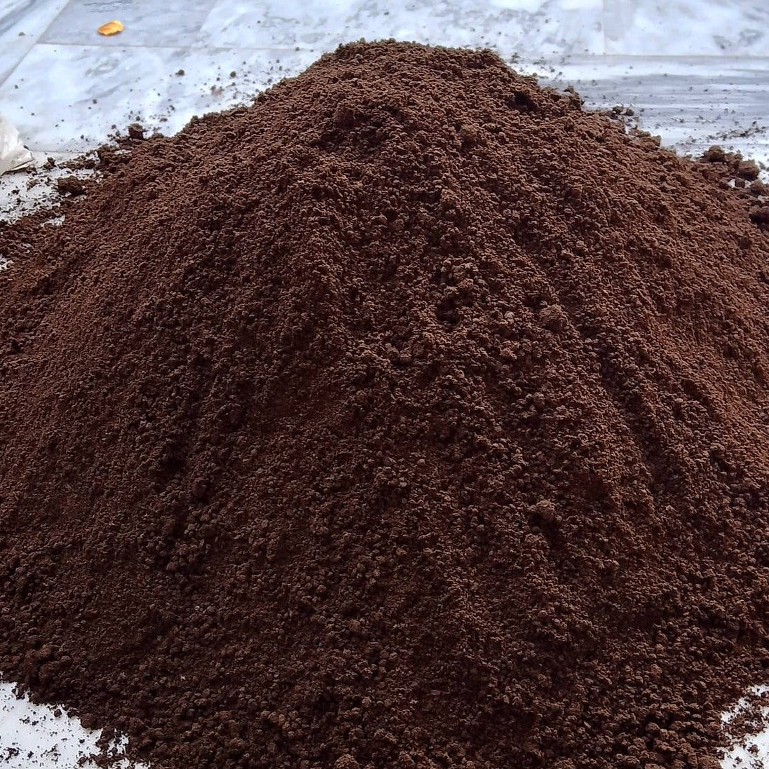 Pile of vermicompost on a concrete surface